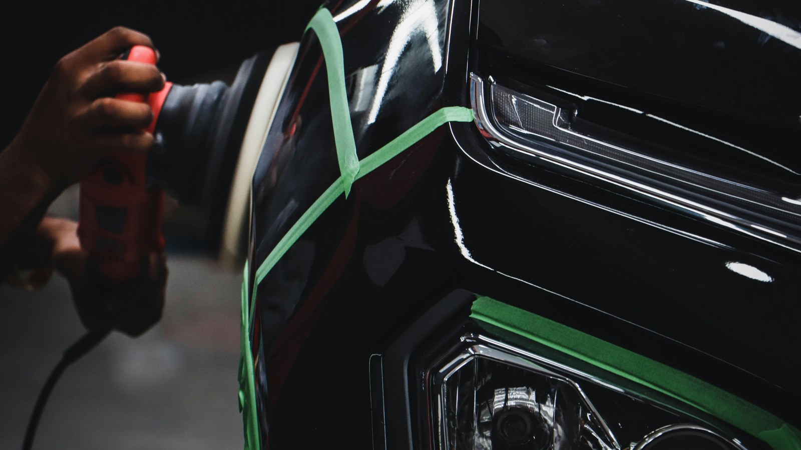 Detailer polishing a car panel during a paint correction