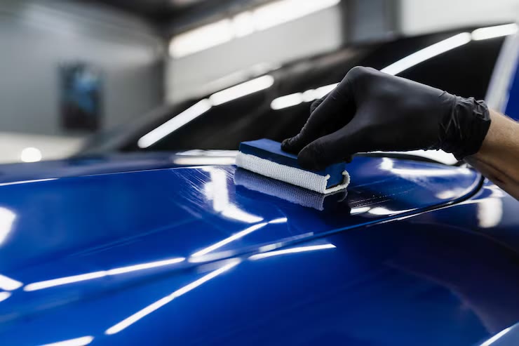 Ceramic coating being applied to a car hood